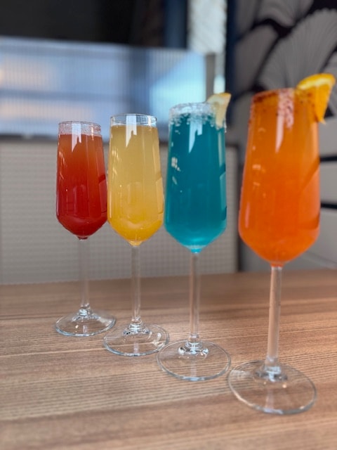 Colorful cocktails lined up on table